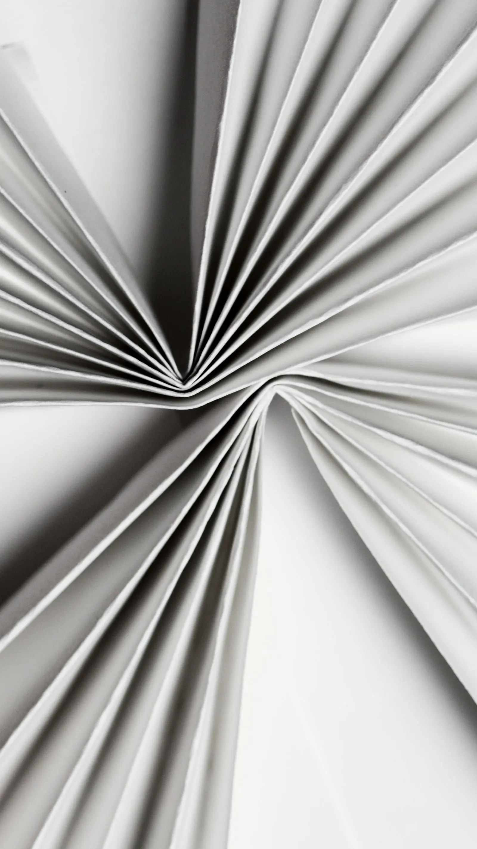 Pliegues esculturales de papel blanco en una composición abstracta